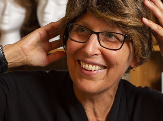 A woman trying on a wig