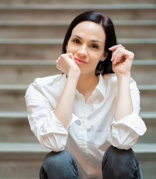 Vanessa sitting on stairs and resting her arms on her knees