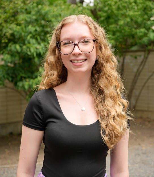 Robyn Grix smiles, looking straight at the camera