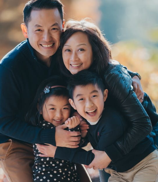 Vivian Chu hugging her husband and two children
