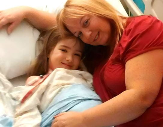 Hailey and Juanita Rodenhiser lying together in a hospital bed.
