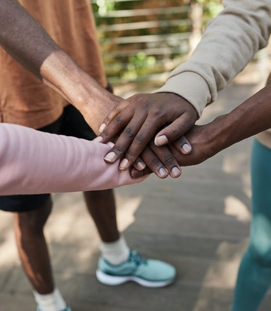 A group of people's hands on top of each other