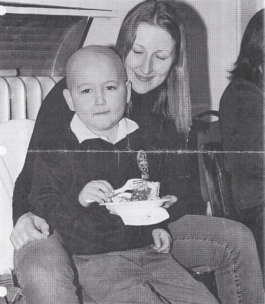 Amory as a little boy sitting on Rochana’s lap.