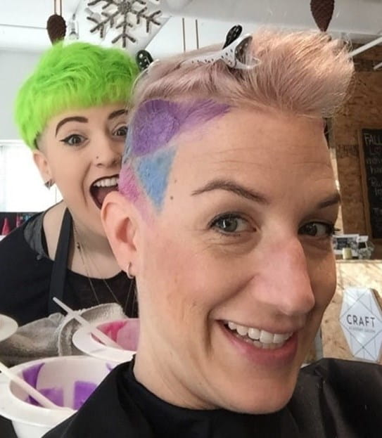 Corinne, having her hair partly shaved and coloured at a hair salon. The hairdresser acting excited.