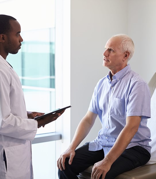 A doctor meeting with a patient in an exam room