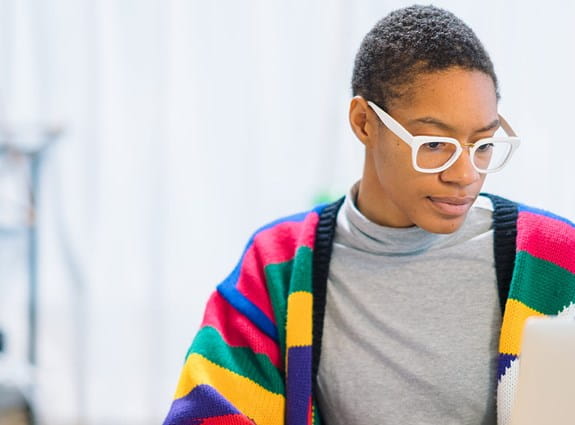 Une femme assise devant son ordinateur portable