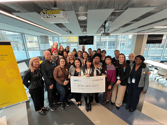 A group of iA Financial and CCS staff members, including Jiwani, at a joint CCS-iA event in Vancouver