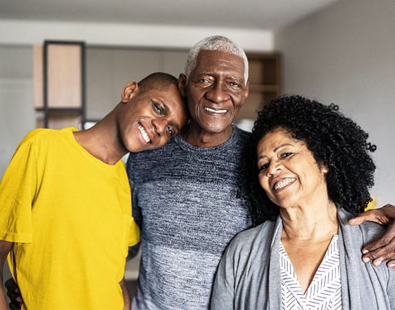 A family stands together smiling